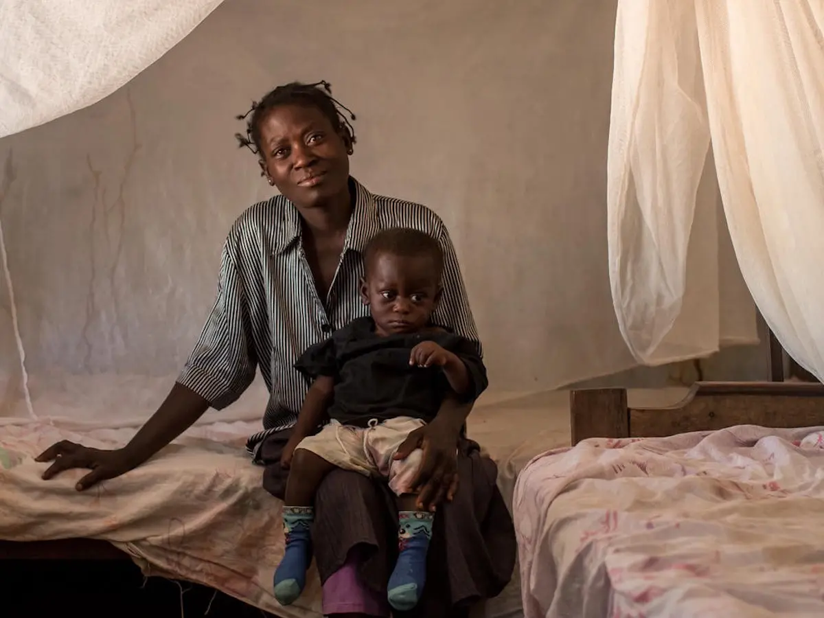Woman Sitting on Bed With Child