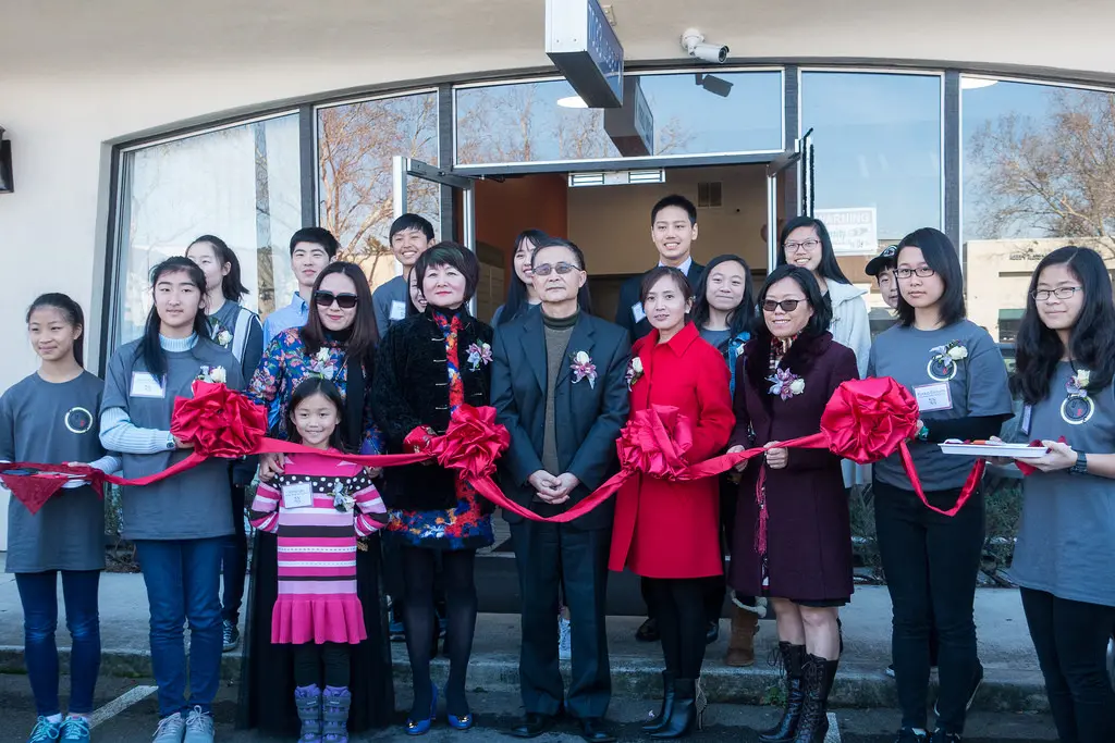 Group of People Holding Ribbon