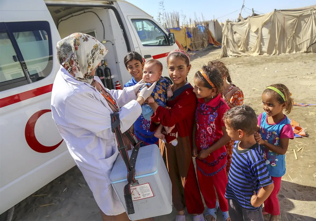 Children Gather Around Aid
