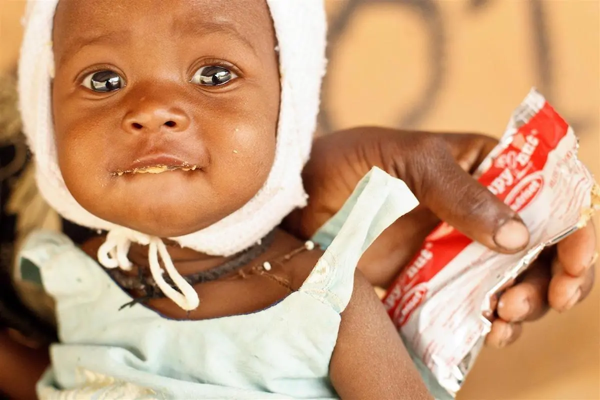 Child Next to Food Pouch
