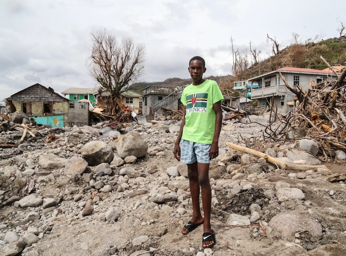 Child Surrounded by Rocks and Rubble