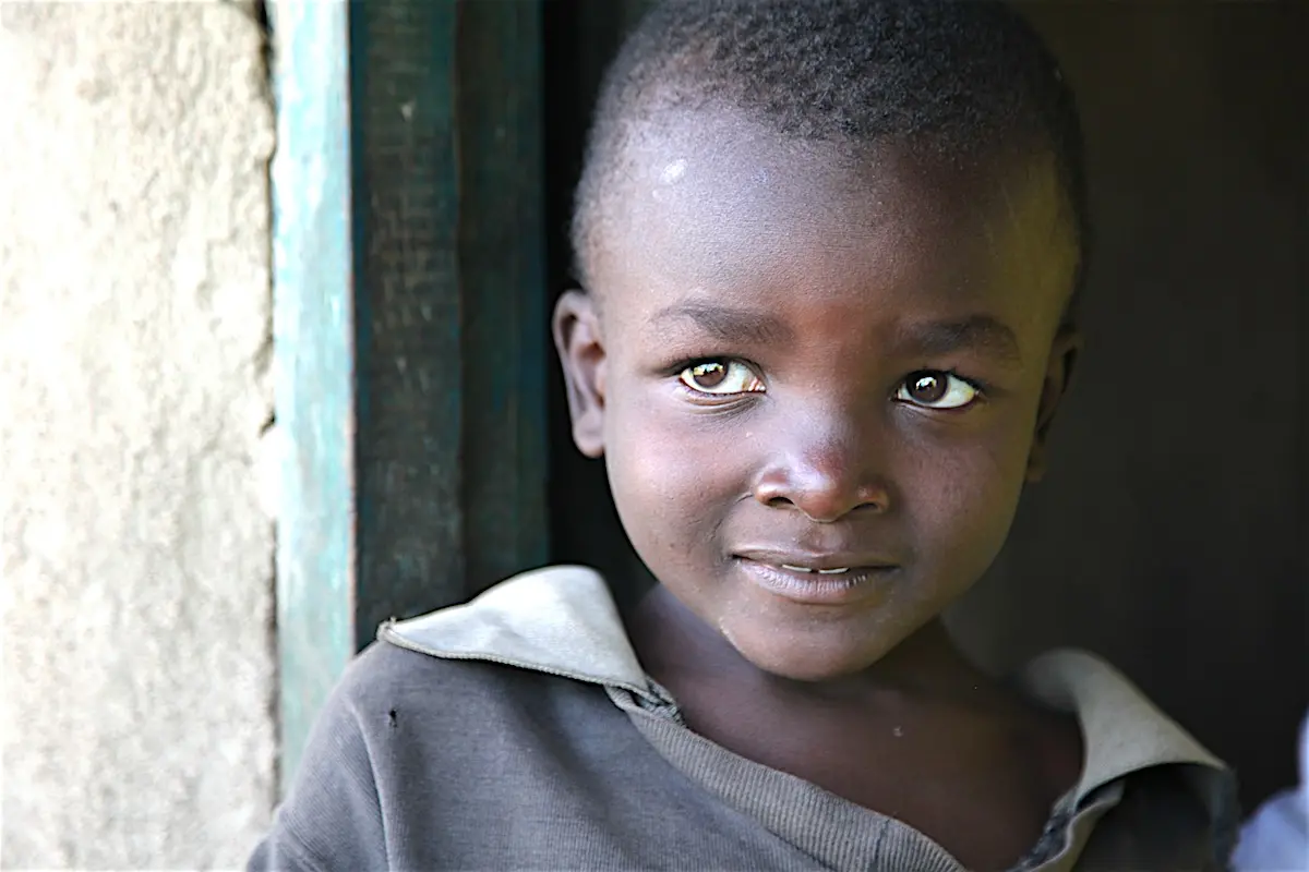 Child Smiling in a Doorway