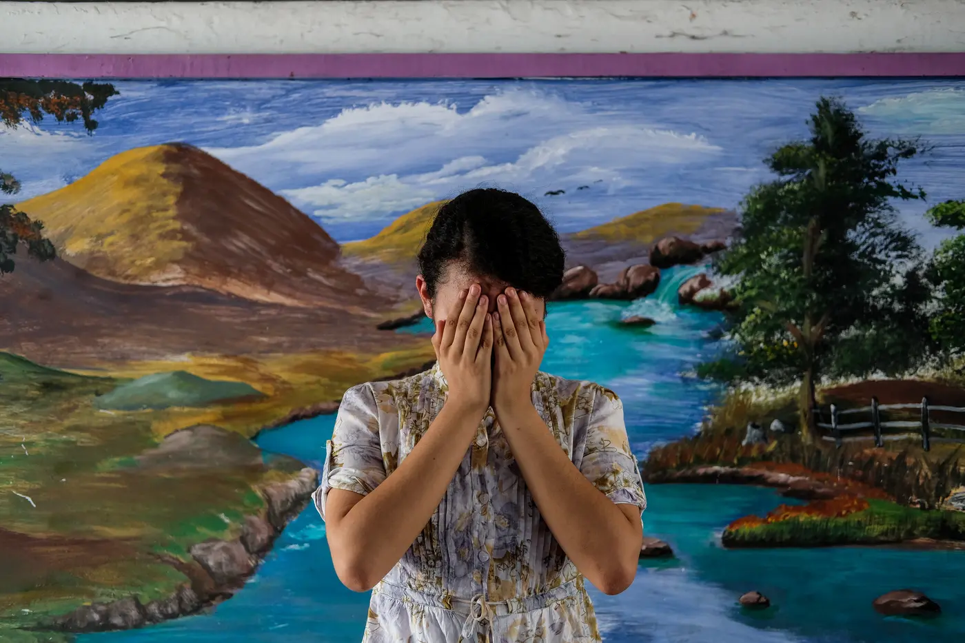 Patricia, 14, covers her face at a school in San Salvador, El Salvador. 