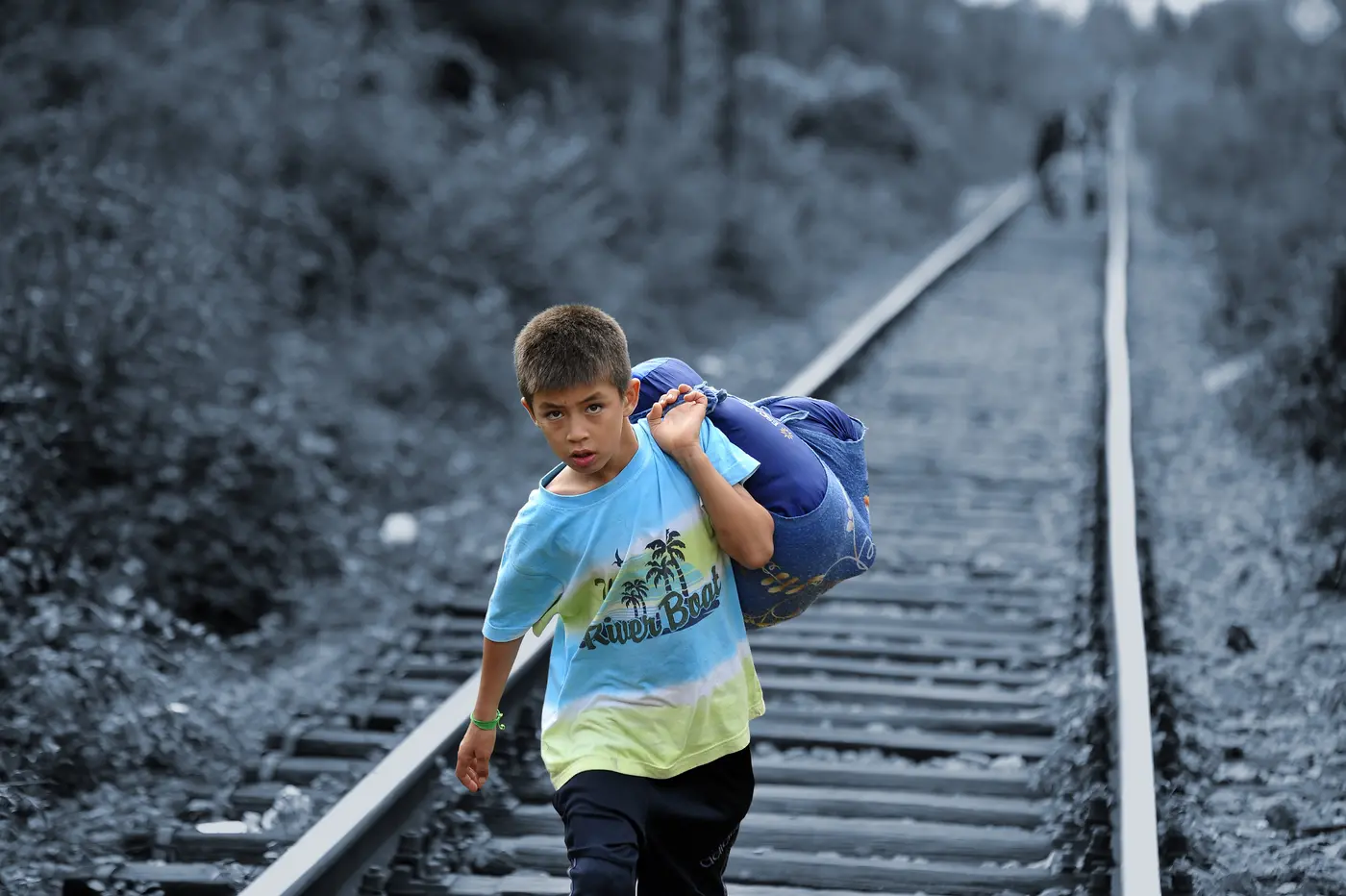 Child Walking on Railroad Tracks