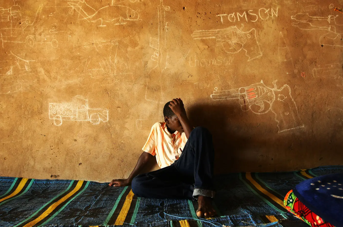 Child Leaning Against a Wall