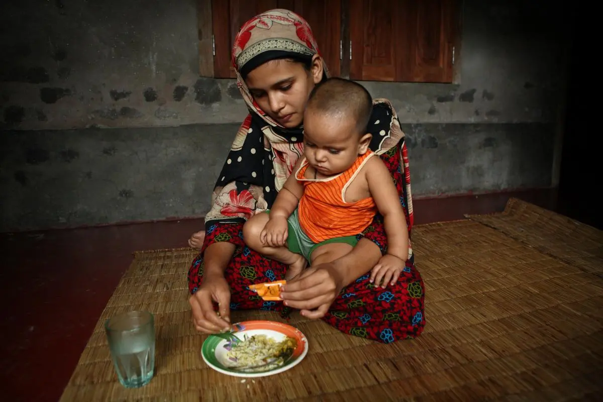 Mother Feeding Child