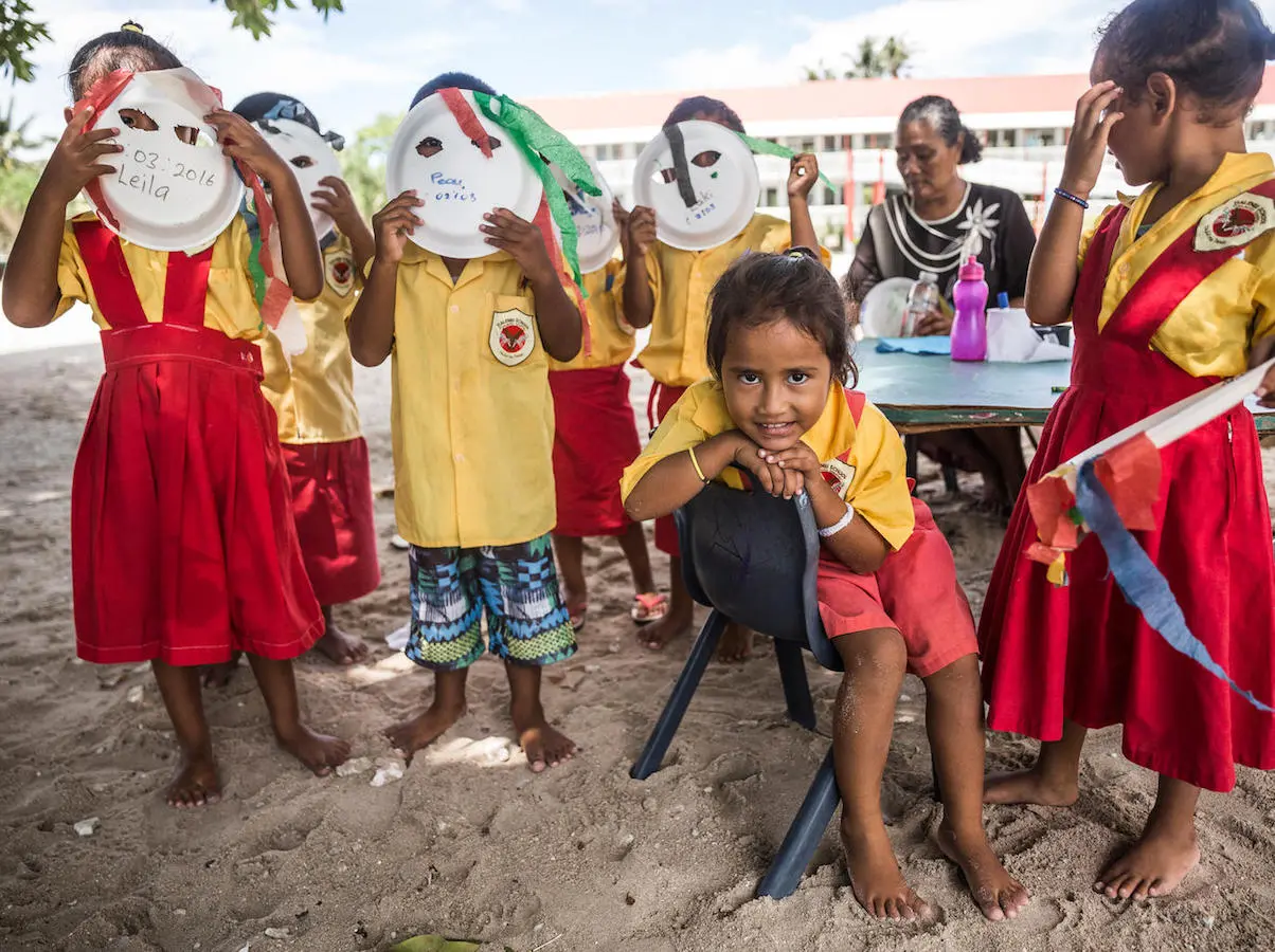 Kindergarteners pose with the masks they made at Tialeniu School in Fakaofo Atoll, Tokelau. UNICEF, Fakaofo Atoll, Tokelau