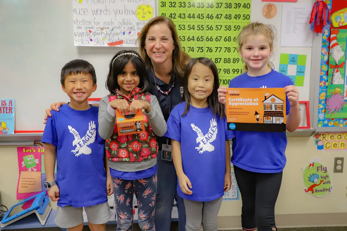Students from Liberty Elementary with their teacher, Andrea Brogan, celebrating another successful Trick-or-Treat for UNICEF fundraising effort.