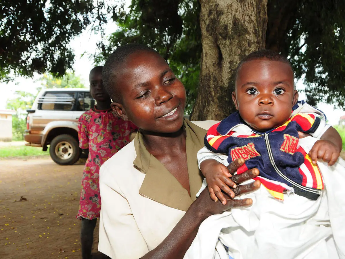 A mother plays with her baby as they wait for immunisation at Apeitolin Health Centre 11,in Napak district, Uganda. UNICEF, Uganda, infant mortality, immunization