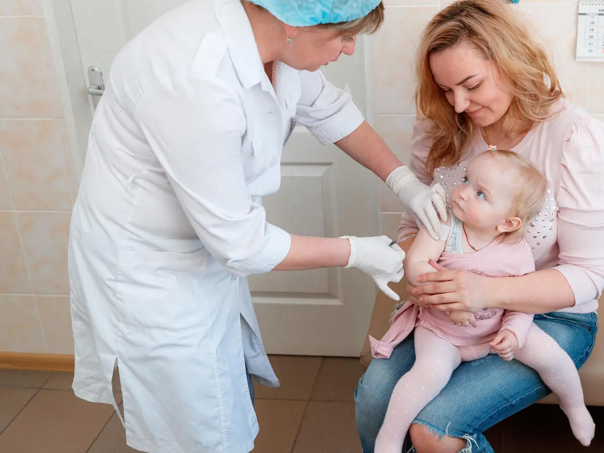 Sitting on her mother's lap, 1-year-old Dana didn't cry while getting her first dose of measles, mumps and rubella (MMR) at Children's Policlinic No. 1 in Obolon district, Kyiv, Ukraine in 2018. Sitting on her mother's lap, 1-year-old Dana didn't cry while getting her first dose of measles, mumps and rubella (MMR) at Children's Policlinic No. 1 in Obolon district, Kyiv, Ukraine in 2018.