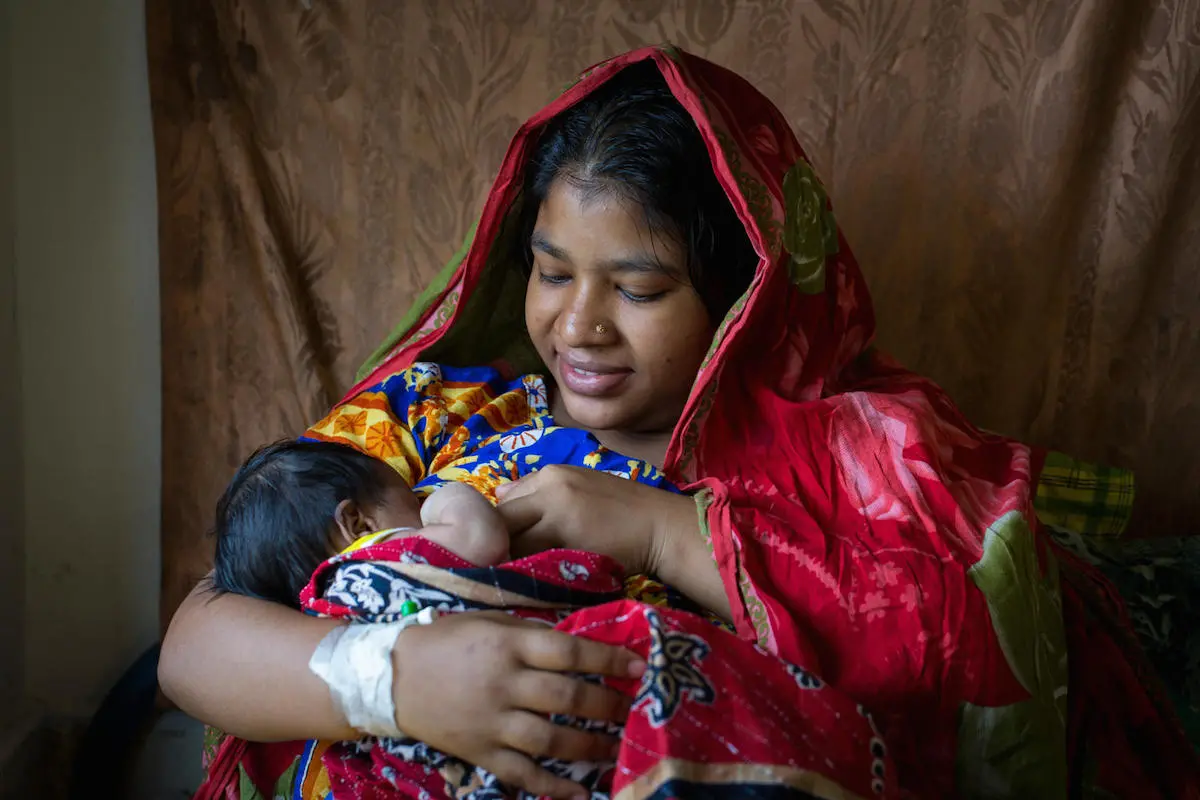 A mother breastfeeds her newborn baby at the maternity ward of a UNICEF-supported district hospital in Bangladesh. A mother breastfeeds her newborn baby at the maternity ward of a UNICEF-supported district hospital in Bangladesh.