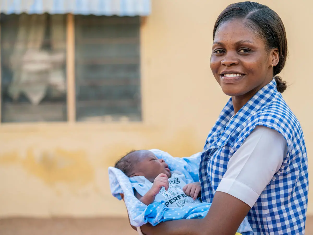 Amilia Mathew, 28, with newborn baby boy Sulaiman outside his home in in Yola, Nigeria. 