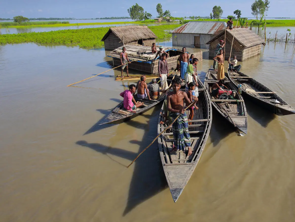 A family take to their boats after severe flooding in 2017 in the northern district of Kurigram, Bangladesh. A family take to their boats after severe flooding in 2017 in the northern district of Kurigram, Bangladesh.