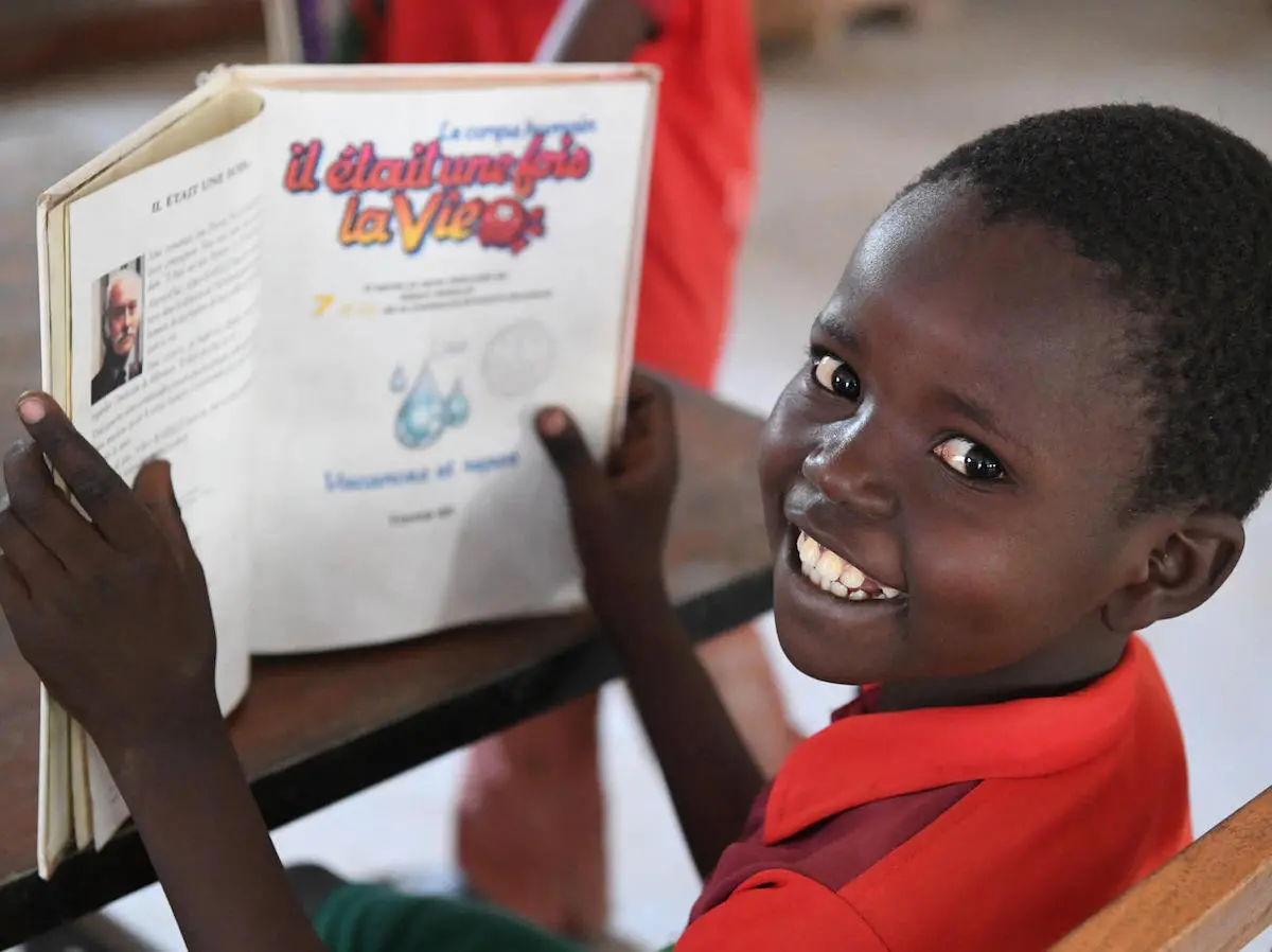 This boy is reading a book in the library of a cultural center in Mongo, Chad. 