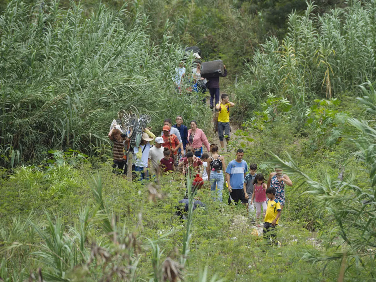 Uncertainty in Venezuela is prompting many to leave for other countries in the region. Here, a group of Venezuelans cross the border in Cucuta, Colombia in April 2019.
