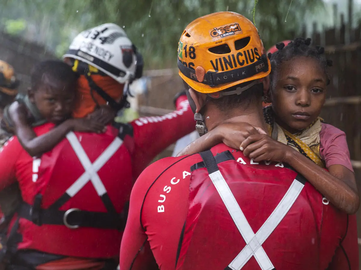 On April 28, 2019, Brazilian military firefighters rescue children in the Shibahuri area of Pemba, Mozambique after heavy rains poured down in the wake of Cyclone Kenneth. 