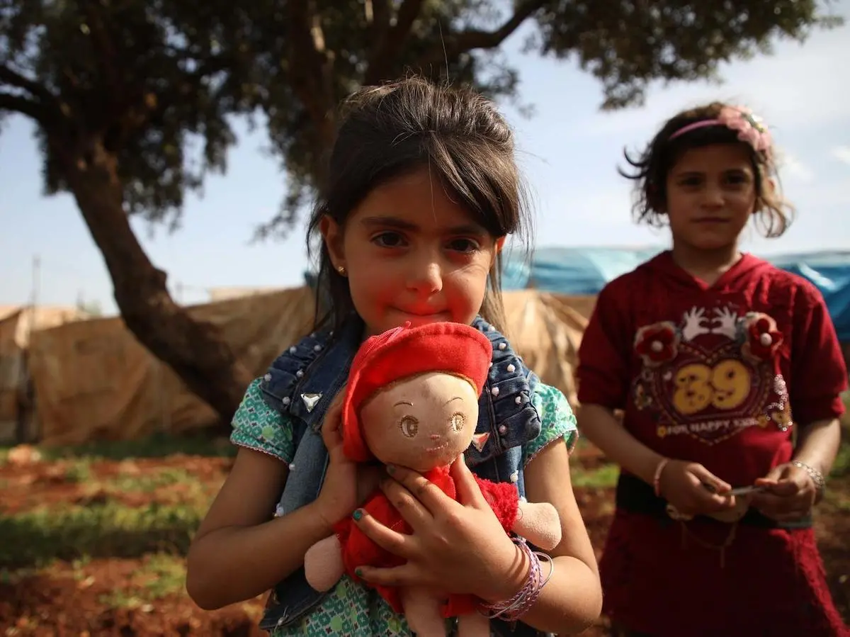 On May 5, 2019, families fleeing escalating violence in Idlib, Syria take shelter in an olive grove near the Turkish border. 