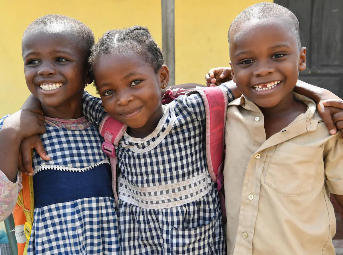 Happy friends leaving their school in Gonzagueville, a suburb of Abidjan, the capital of Côte d'Ivoire.
