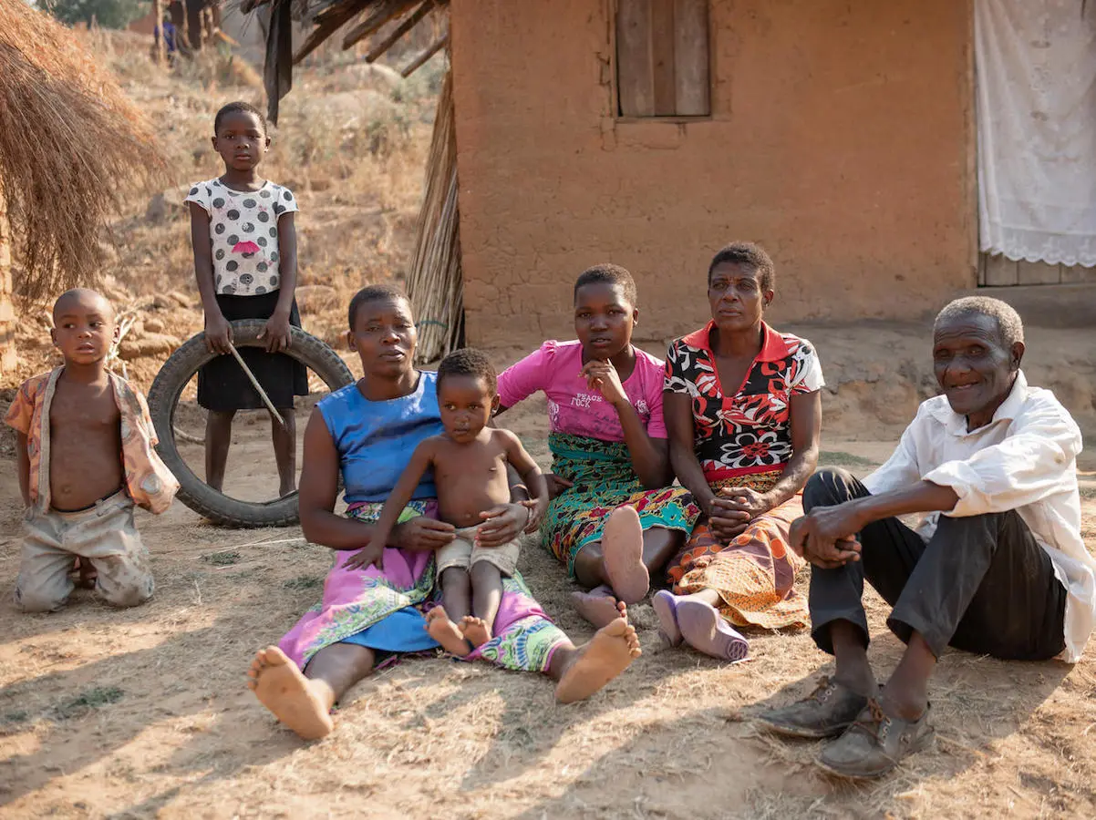 In Malawi's Ntcheu District, Wilson Kamwana, 84, far right, and his extended family use the $7 a month they receive from a UNICEF-supported unconditional cash transfer program to pay for basic necessities like soap, salt, sugar and school supplies. In Malawi's Ntcheu District, Wilson Kamwana, 84, far right, and his extended family use the $7 a month they receive from a UNICEF-supported unconditional cash transfer program to pay for basic necessities like soap, salt, sugar and school supplies.