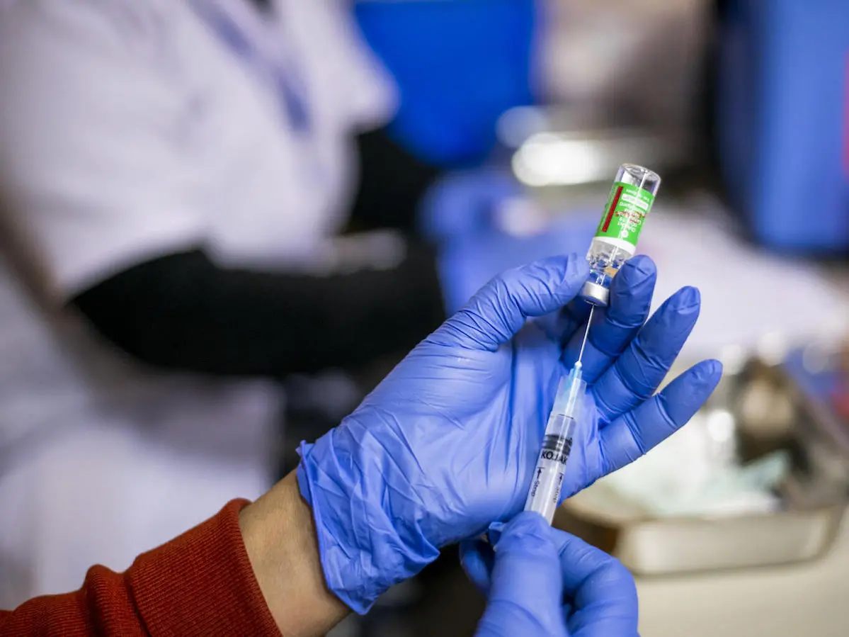 In January 2021, a nurse prepares to administer a COVID-19 vaccine at Sitaram Bhartiya Institute of Science & Research in New Delhi, India. 