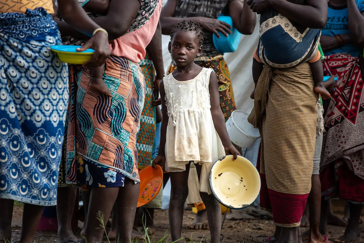 Displaced children and families queue for food at a relief distribution point outside the port city of Beira, where Cyclone Eloise made landfall on Jan. 23.