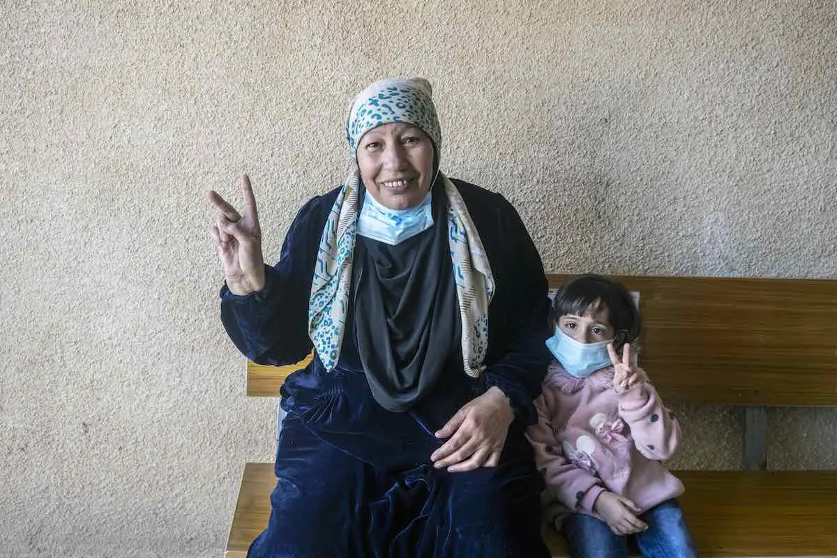 Woman and Child Holding Up Peace Signs