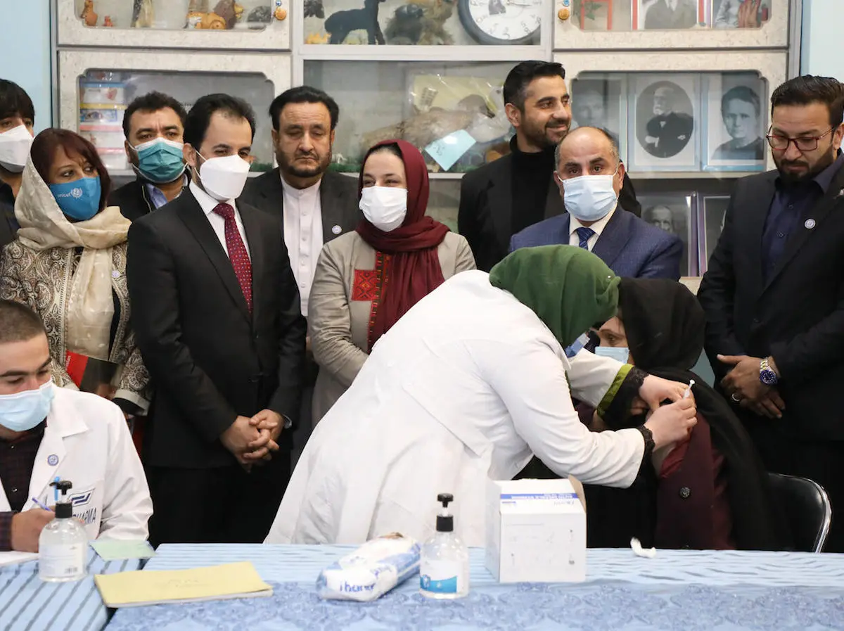 Ms. Palwasha Rafi Najemi, 40, principal of the Khwajah Rawash Girls High School receives the COVAX-facilitated COVID-19 vaccine at the Al-Fateh girls’ high school in Kabul, Afghanistan. 