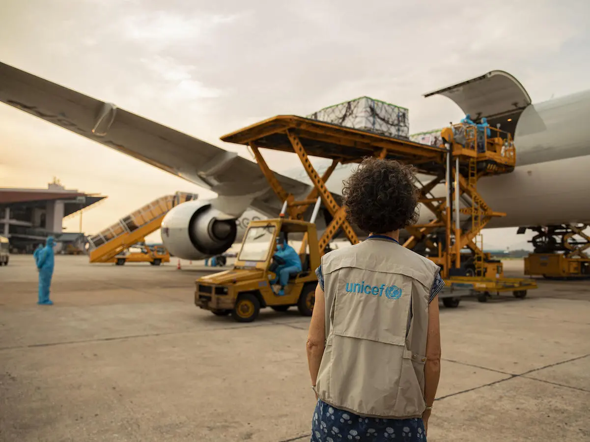 UNICEF Vietnam Deputy Representative Lesley Miller watches as COVID-19 vaccine doses donated by the U.S. Government through the COVAX dose-sharing mechanism are unloaded in Hanoi on July 25, 2021.