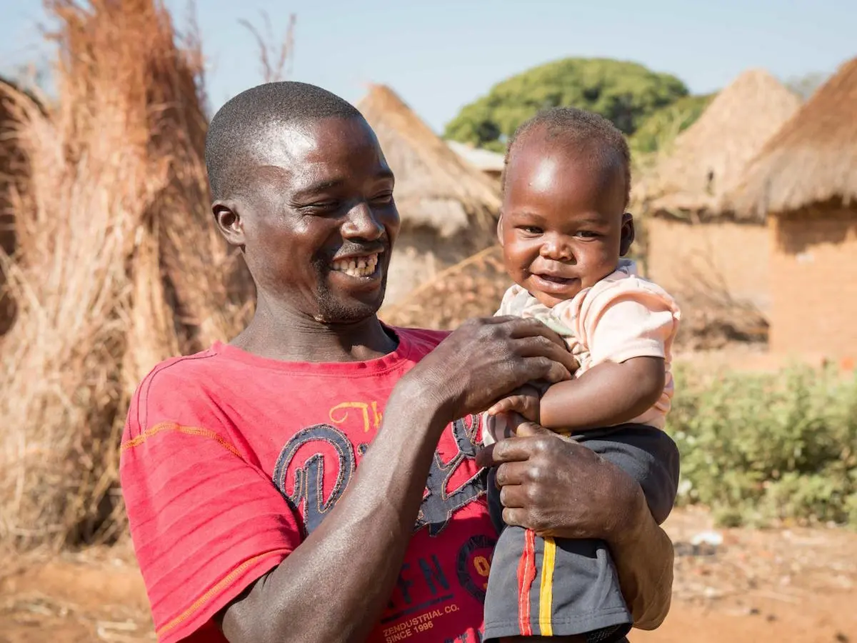 One-year-old baby Moses and father Ponsilio Phiri playing in Zambia in 2020. Baby Moses is enrolled in the LEGO Playful Parenting program implemented by UNICEF. One-year-old baby Moses and father Ponsilio Phiri playing in Zambia in 2020. Baby Moses is enrolled in the LEGO Playful Parenting program implemented by UNICEF.