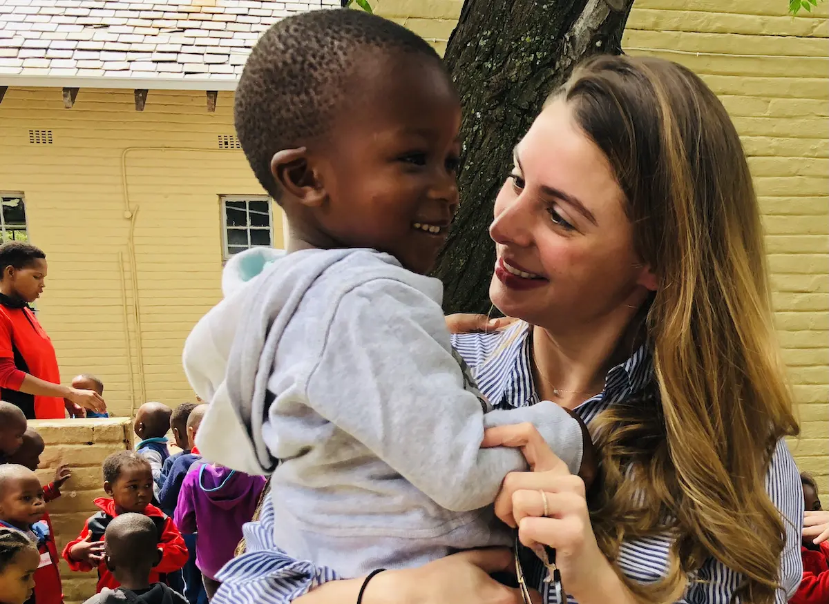 UNICEF Next Generation Global Principal Emily Watts Johnson bonds with a child during a program visit with UNICEF in 2021. UNICEF Next Generation Global Principal Emily Watts Johnson bonds with a child during a program visit with UNICEF in 2021.