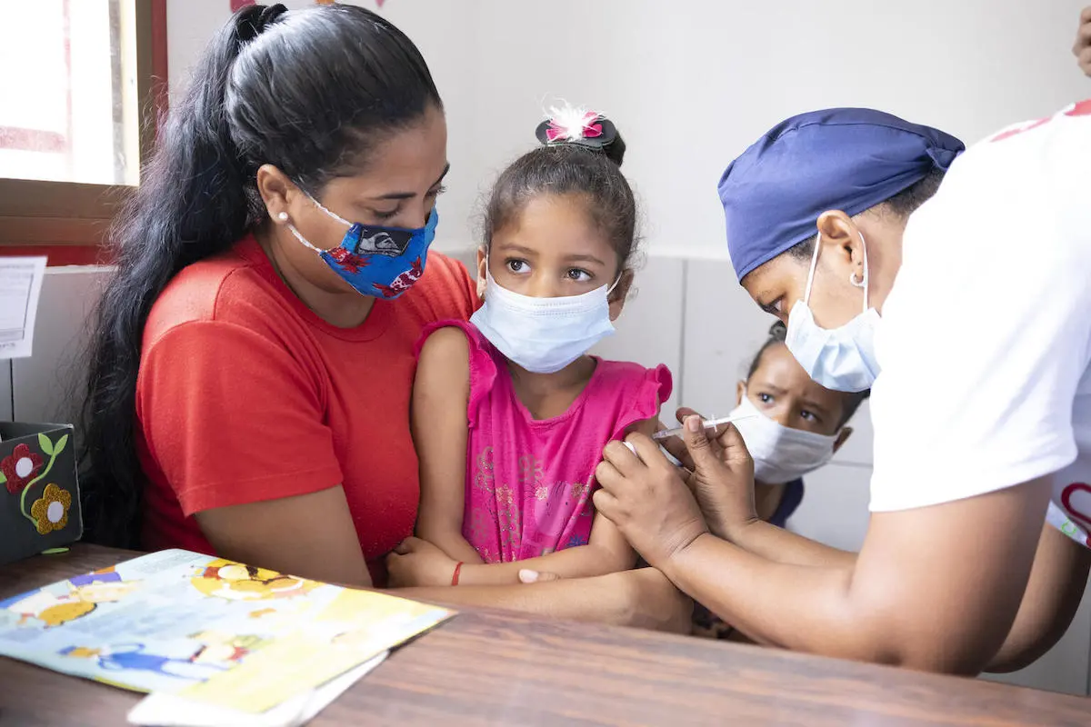 Sabrielys, 6, is vaccinated during a UNICEF-supported immunization campaign in San Vicente community, Miranda state, Venezuela.