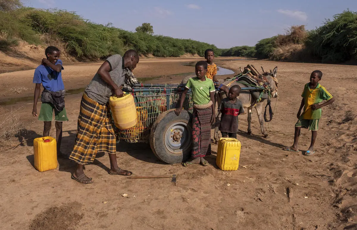 In Somalia, Ibrahim, second from left, collects what little water he can from a dried up riverbed with help from his young sons and a nephew. In Somalia, Ibrahim, second from left, collects what little water he can from a dried up riverbed with help from his young sons and a nephew.