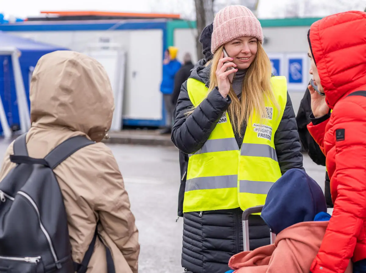 Anastasia, a refugee from Ukraine, volunteers as a translator for newly arrived families at a UNICEF Blue Dot center in Siret, Romania.