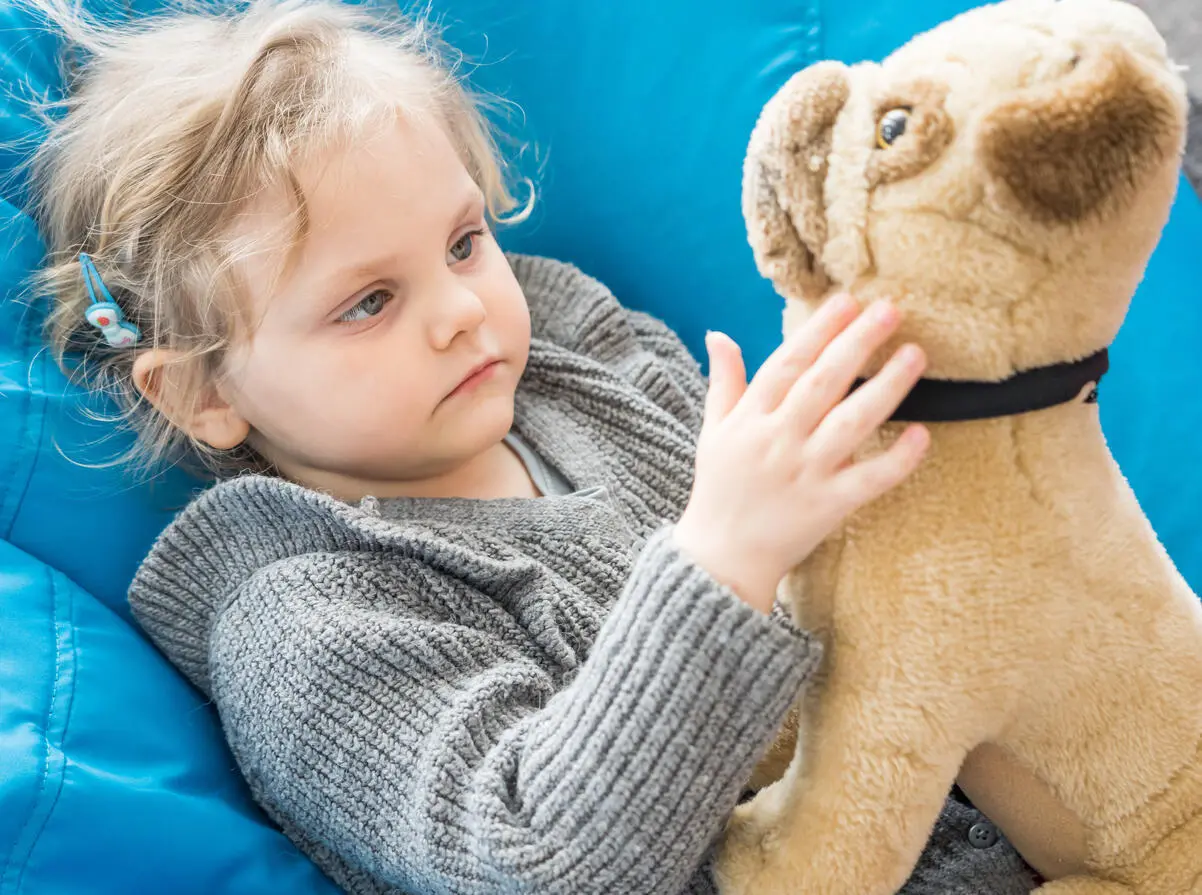 A child play with her toy in the activity room in a UNICEF-UNHCR Blue Dot center in Brasov, Romania