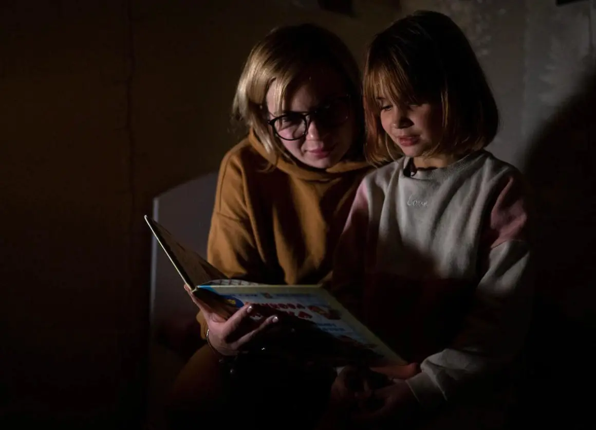 In Bucha, Ukraine, 7-year-old Varvara reads her favorite fairy tale, the story of a fox who is afraid of the spring, by candlelight. In Bucha, Ukraine, 7-year-old Varvara reads her favorite fairy tale, the story of a fox who is afraid of the spring, by candlelight.