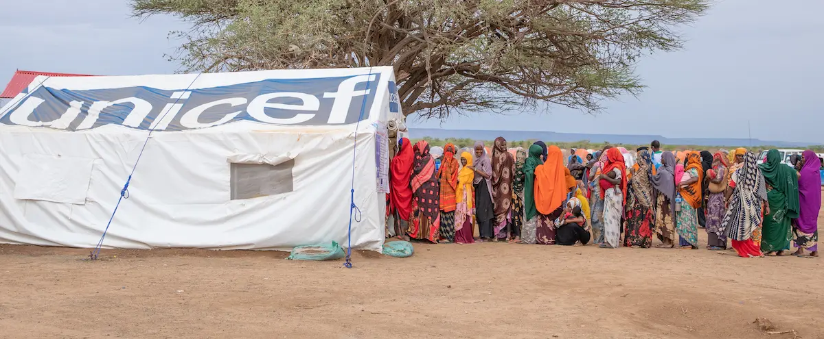 Women and children queue for health and nutrition services from UNICEF and partners at the Higlo site for displaced families in Ethiopia.