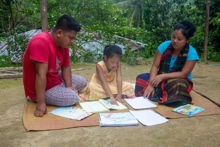 Adults Teaching Child to Read