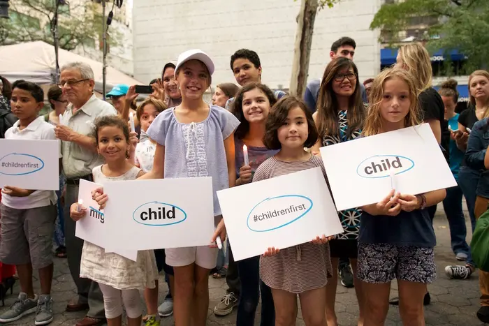 Children Holding Up Signs