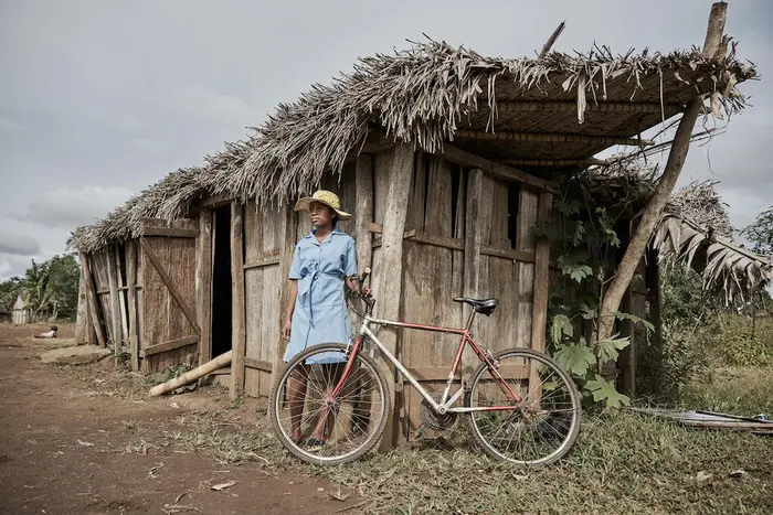A young girl stands by her cyclone-ravaged classroom in Irondro, a village in the Mananjary district of Vatovavy region, Madagascar, on July 10, 2023.