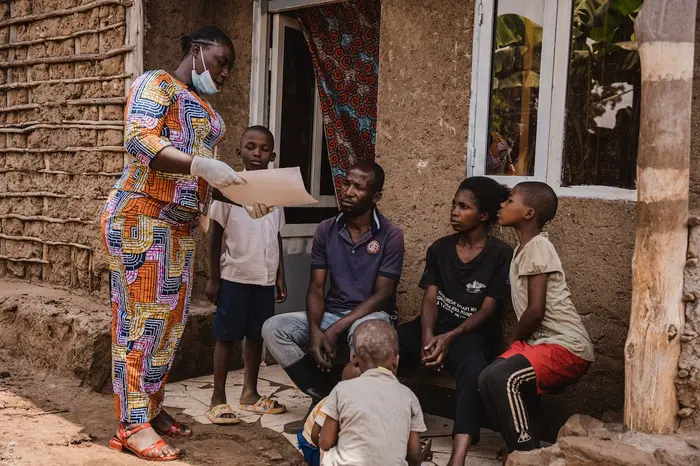 Mwamini Badesire, a community leader and UNICEF-supported community outreach worker, raises awareness about mpox symptoms and prevention measures with the Amani family in Chireja village, South Kivu province, DR Congo, on Sept. 13, 2024.