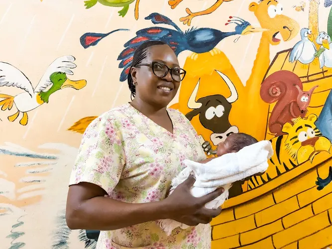 Nurse holding infant in neonatal department in Central African Republic 