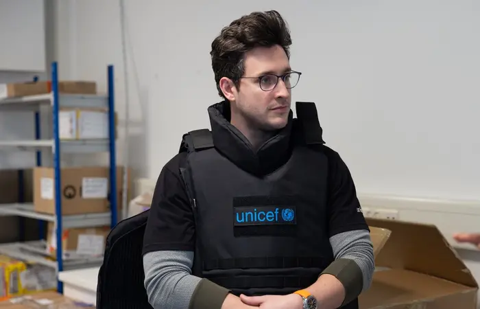 UNICEF Ambassador Doctor Mike samples UNICEF safety gear during visit to the Copenhagen supply warehouse.