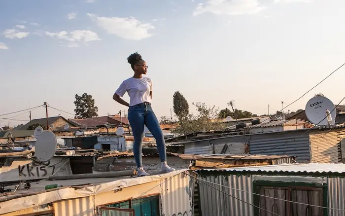 18-year-old stands on top of her family home in the Ivory Park settlement outside Johannesburg, South Africa