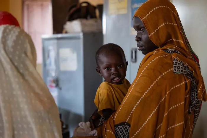 A mother with a child receiving nutrition services at a UNICEF-supported clinic in Khartoum state, Sudan.
