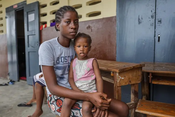In Haiti, Naika Bienvil, 21, and her 2-year-old daughter take refuge in a school converted into a shelter as Hurricane Melissa approaches.
