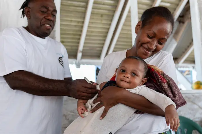 A health worker uses a MUAC tape to assess the nutritional status of a 5-month-old baby on Pele Island, Efate, SHEFA, Vanuatu on Oct. 9, 2025.