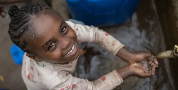 A girl in Ethiopia washes her hands at a UNICEF-supported water point.
