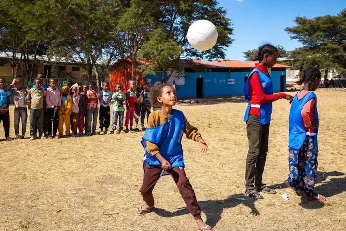 In Abiy Adi, Ethiopia, a 9-year-old girl plays volleyball at the school where she is learning and thriving with UNICEF support.