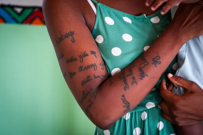 The tattooed arm of a victim of trafficking receiving services at a UNICEF-supported transit center in Gabon.