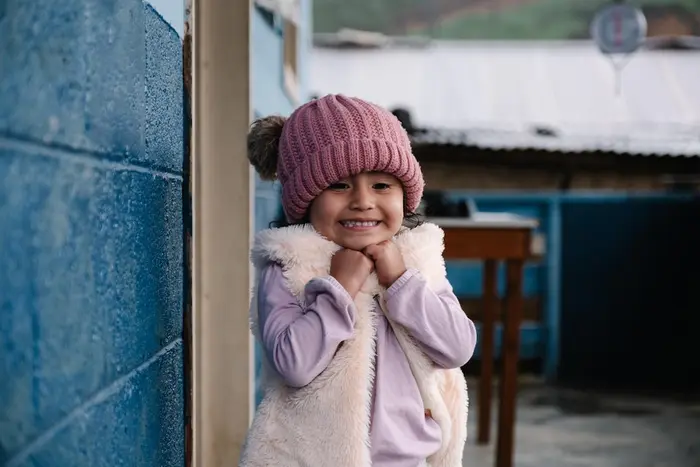 On March 17, 2025 in Chiretzaaj, Cob&aacute;n, Guatemala, 3-year-old Amani smiles outside the local health center.